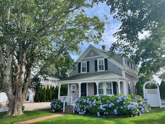 a-nice-blue-house-with-flowers-in-the-front-yard